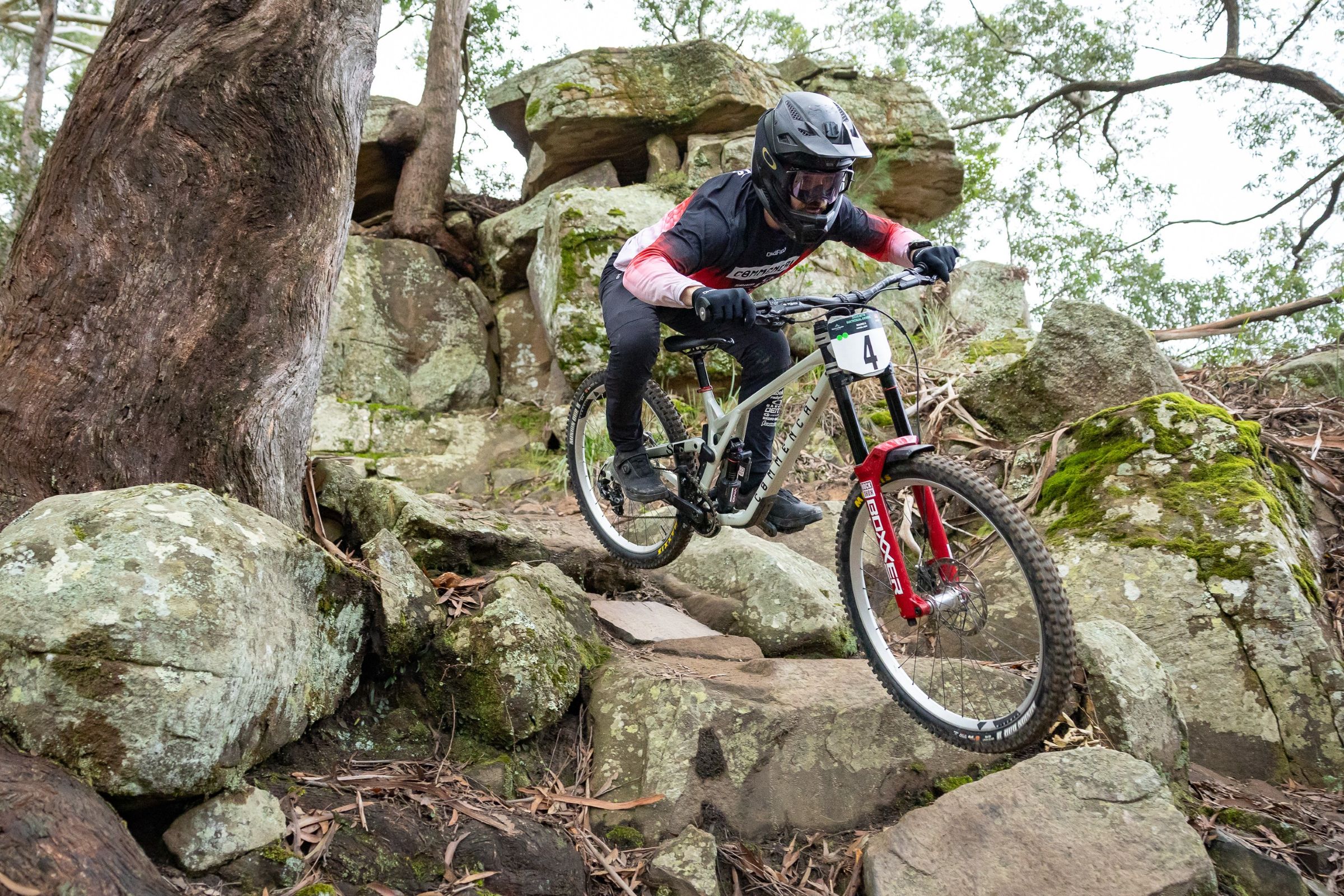 A downhill rider enters the rock garden at Awaba during the the AusCycling Downhill Mountain Bike National Series